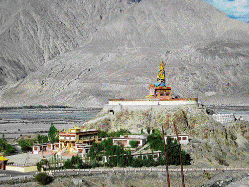 Mystique: The 32-metre statue of Maitreya Buddha in Diskit Monastery; a Bactrian camel strikes a pose in Nubra. photos by author