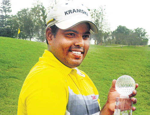 All smiles: Sri Lanka's Mithun Perera  poses with the PGTI Eagleburg Open title in Bangalore on Saturday.