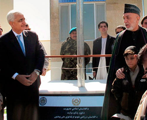 Foreign Minister Salman Khurshid and Afghan President Hamid Karzai during the inauguration ceremony of the Afghan National Agriculture Science and Technology University, in Kandahar province south of Kabul, Afghanistan, Saturday. PTI Photo