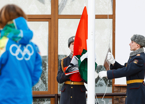 Russian soldiers raise India's national flag during the welcoming ceremony for the team in the Olympic athlete's village, which stands on a mountain plateau in Rosa Khutor, during the 2014 Winter Olympic Games February 16, 2014. India has returned to the Olympic fold after the IOC lifted a ban on the country's Olympic association on Tuesday, and its athletes will now be able to march behind the Indian flag at the closing ceremony of the Sochi Winter Games. REUTERS