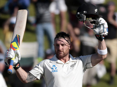 New Zealand's Brendon McCullum signals his 100 against India during the second innings on day three of the second international test cricket match at the Basin Reserve in Wellington, February 16, 2014. REUTERS