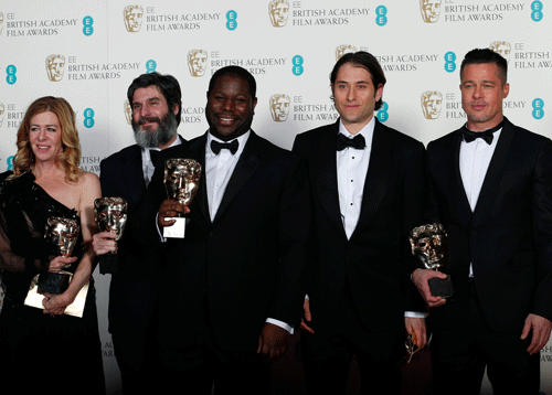 Director Steve McQueen (C) celebrates with Dede Gardner (L-R), Anthony Katagas, Jeremy Kleiner and Brad Pitt after winning Best Film for '12 Years a Slave' at the British Academy of Film and Arts (BAFTA) awards ceremony at the Royal Opera House in London February 16, 2014. REUTERS