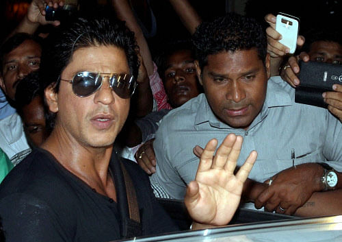 File photo of Bollywood actor Shahrukh Khan waving to his fans after being discharged from the Lilavati hospital after shoulder operation, in Mumbai. PTI Photo by Santosh Hirlekar