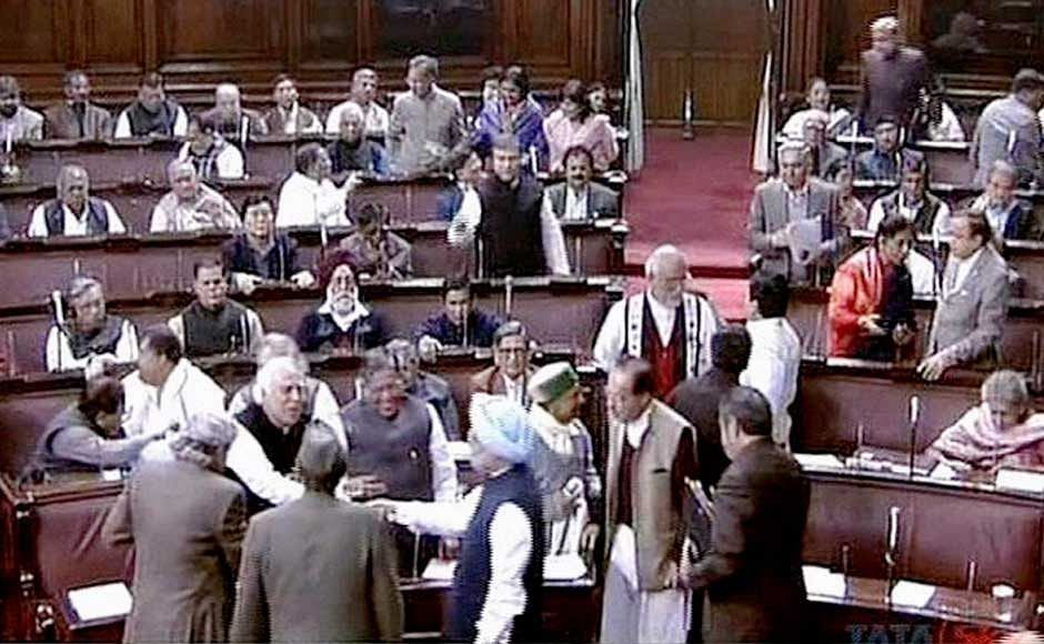 Prime Minister Manmohan Singh greeting Union Law Minister Kapil Sibal in the Rajya Sabha after it passed the Lokpal Bill. PTI File Photo