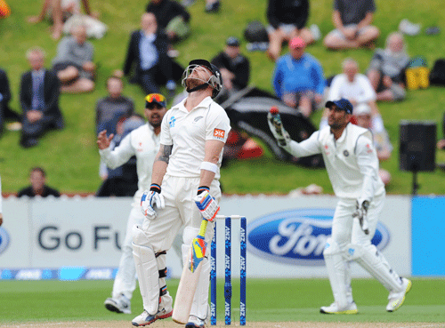 New Zealand's Brendon McCullum, center, looks skyward after being caught out by MS Dhoni off the bowling of Zaheer Khan for 302 on the final day of the second test at the Basin Reserve in Wellington, New Zealand, Tuesday, Feb. 18, 2014.  AP