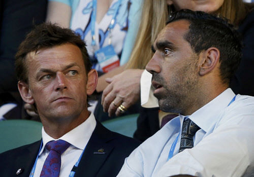 Adam Gilchrist sits with Australian Football League (AFL) player Adam Goodes in the spectator stands ahead of the men's singles final match between Rafael Nadal of Spain and Stanislas Wawrinka of Switzerland at the Australian Open 2014 tennis tournament in Melbourne January 26, 2014. REUTERS/Jason Reed