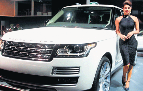 Hindi movie actress Priyanka Chopra poses with Jaguar Land Rover's Range Rover LWB during its unveiling at the 12th Auto Expo 2014 in Greater Noida. PTI