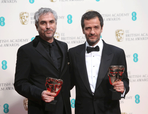 Alfonso Cuaron and David Heyman, winners of outstanding British film for Gravity, pose for photographers in the winners room at the EE British Academy Film Awards held at the Royal Opera House on Sunday Feb. 16, 2014, in London. AP photo