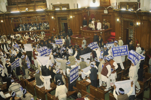 Members of Uttar Pradesh Assembly holding placards during their protest in the House in Lucknow on Wednesday. PTI Photo