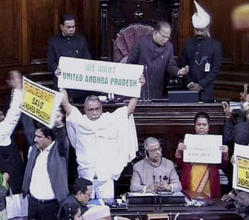 Amid unprecedented bedlam, Home Minister Sushilkumar Shinde moved the Telangana bill in Rajya Sabha for consideration leading to three adjournments within 30 minutes. PTI Photo