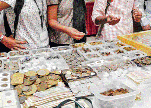 Visitors at the national numismatics exhibition in Bangalore on Friday. DH Photo