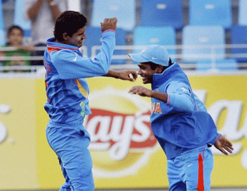 Under- 19 cricketers Deepak Hooda and Sanju Samson celebrating after taking a wicket during the ICC U-19 World Cup in Dubai on Saturday. PTI