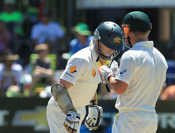 Australia's batsman Chris Rogers, left, has a word with teammate David Warner, right, on the fourth day of their second cricket test match against South Africa at St George's Park in Port Elizabeth, South Africa, Sunday, Feb. 23, 2014. (AP)