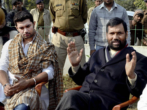 LJP chief Ram Vilas Paswan addresses a press conference along with his son Chirag Paswan at party office in Patna. PTI photo