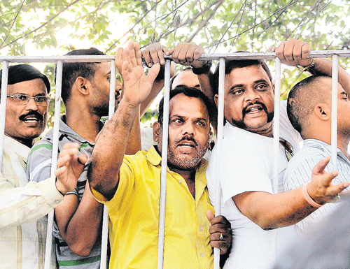 concerned: Housing Minister and actor Ambarish's fans gather outside the Vikram Hospital, where he has been undergoing treatment, in Bangalore on Sunday. dh photo
