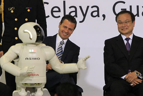 Honda Motor Co's President and Chief Executive Officer Takanobu Ito (R) sits next to Mexican President Enrique Pena Nieto as they watch Honda's ASIMO robot entertain the crowd. Ray Kurzweil, Google's director of engineering, has predicted that by 2029, computers will be cleverer than humans and will be able to understand what we say and tell stories. Reuters Photo