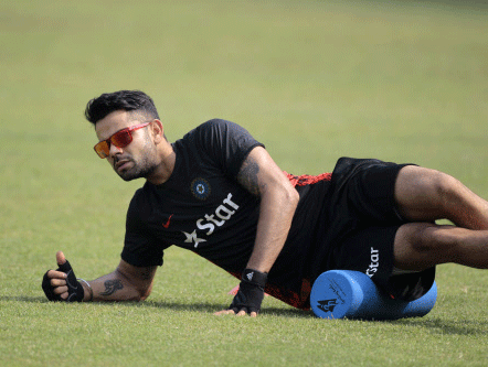 India cricket team captain Virat Kohli stretches during a practice session ahead of the Asia Cup tournament in Dhaka, Bangladesh, Monday, Feb. 24, 2014. Pakistan plays Sri Lanka in the opening match of the five nation one day cricket event that begins Tuesday. AP photo