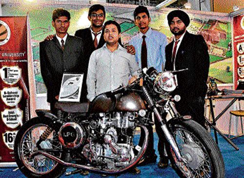 innovative Students with their engineering marvel, the duel-fuel bike 'Thud Duo'.