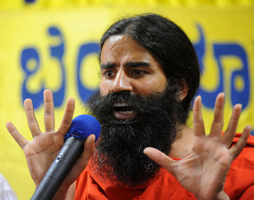 Yoga guru Ramdev today made a veiled attack on Congress Chief Sonia Gandhi and her son Rahul on the foreign origin issue. DH File Photo