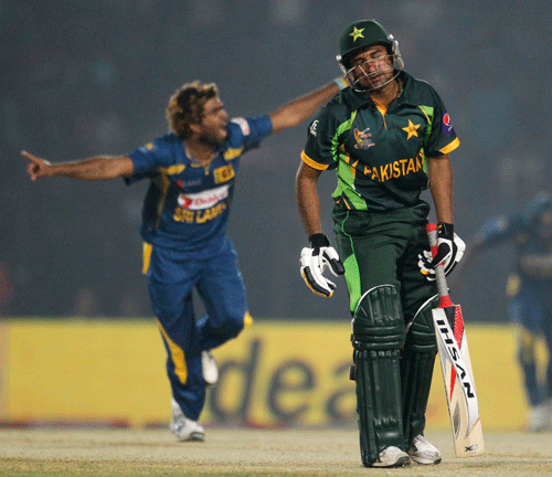 Pakistan's Bhatti reacts as Sri Lanka's Malinga celebrates his dismissal during their ODI cricket match for the Asia Cup 2014 in Fatullah