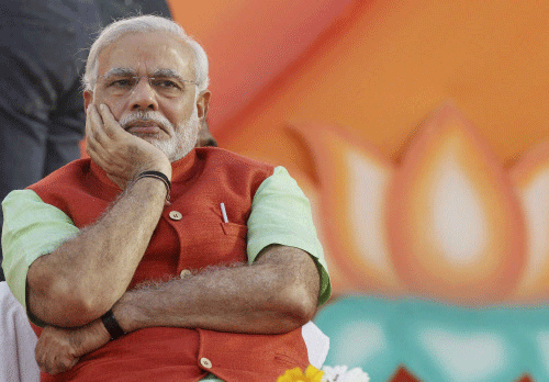 Though downside risks to the economy have receded in recent months, it is likely that the growth engine will continue to sputter until 2015 even if "business-friendly" Narendra Modi becomes prime minister, says a report by rating agency Moody's analytical arm. AP photo