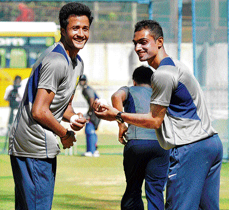 speed merchants: Karnataka pacemen HS Sharath (left) and A Mithun share a light                        moment during a practice session in Bangalore on Wednesday. DH photo/ srikanta sharma r