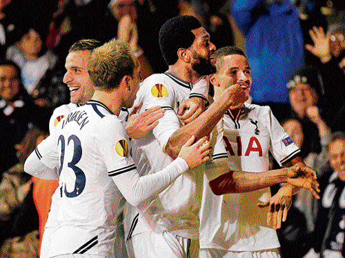 man on fire: Tottenham Hotspurs' Emmanuel Adebayor (centre) celebrates with team-mates after scoring on Thursday. AFP