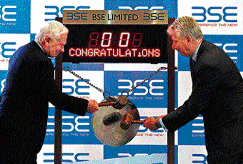 Canada Governor General David Johnston (left) and Stewart Beck, Canadian High Commissioner to India, hit the ceremonial gong at the BSE on Friday. REUTERS