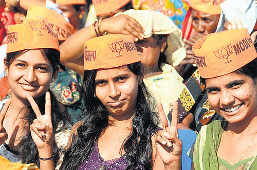 Supporters of BJP's prime ministerial candidate Narendra Modi at a rally in Hubli on Friday. PTI