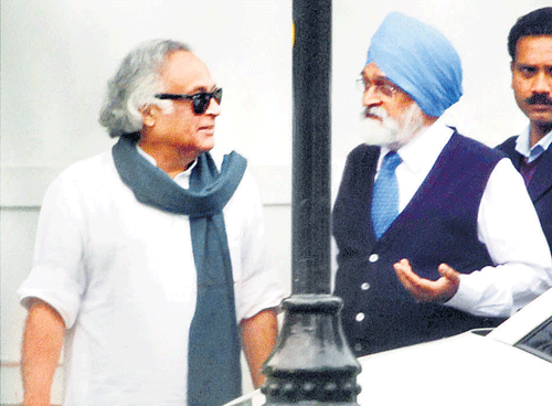 MISSION ACCOMPLISHED: Rural Development Minister Jairam Ramesh with Deputy Chairman of the Planning Commission Montek Singh Ahluwalia after a cabinet meeting at the prime minister's residence in New Delhi on Friday. Pti