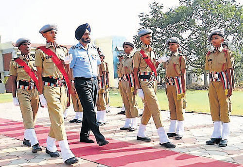 Gp Capt Surinder Singh, Inspecting Officer, Sainik School Society, New Delhi, receives guard of honour from cadets of Sainik School.