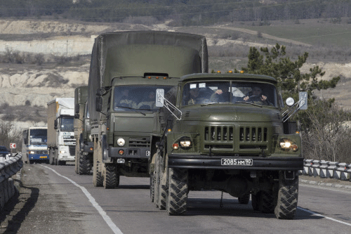 Russian Army trucks drive on the road from Sevastopol to Simferopol in the Crimea region March 1, 2014. Armed men took control of two airports in the Crimea region on Friday in what Ukraine's government described as an invasion and occupation by Russian forces, raising tension between Moscow and the West. REUTERS