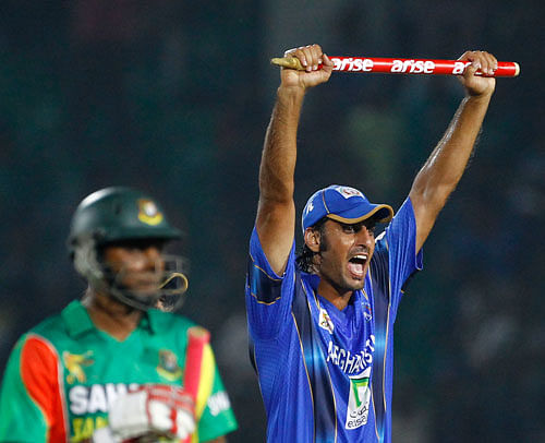 Afghanistan's Shapoor Zadran, right, celebrates with a stump after winning the Asia Cup one-day international cricket tournament against Bangladesh in Fatullah, near Dhaka, Bangladesh, Saturday, March 1, 2014. AP