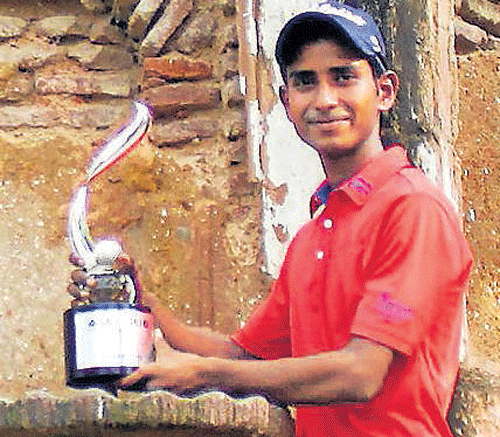 ALL SMILES: Rashid Khan poses with the SAIL-SBI Open trophy at the Delhi Golf Club on Saturday.