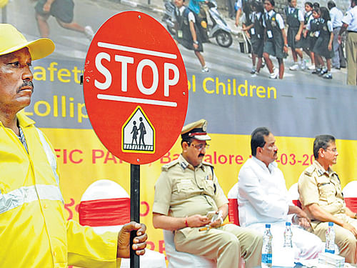 Police commissioner Raghavendra Auradkar, Home Minister K J George and Additional Commissioner of Police (Traffic) B Dayananda at the launch of 'Lollipop Man', an initiative to help children cross roads near schools, in the City on Saturday. DH Photo