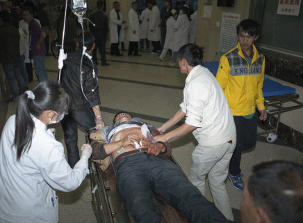 An injured man is pushed on a gurney at a hospital after a knife attack at Kunming railway station, Yunnan province, March 1, 2014. China blamed militants from the restive far western region of Xinjiang on Sunday for an attack at a train station on the other side of the country by knife-wielding 'terrorists' in which at least 33 died, including four of the assailants, who were shot dead. Picture taken March 1, 2014. REUTERS