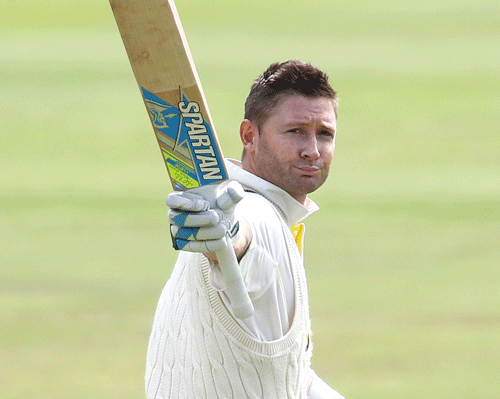 Australian captain Michael Clarke raises his bat after reaching his century during day two of the 3rd Test between South Africa and Australia held at Newlands in Cape Town, South Africa, Sunday, March 2, 2014. (AP Photo/Shaun Roy)