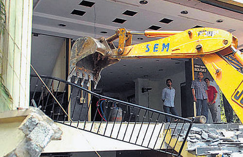 A structure, built on encroached land, being demolished in  Bangalore on Tuesday. DH Photo