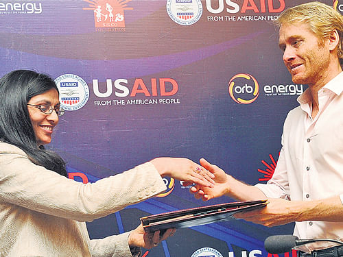 US Assistant Secretary of State for South Nisha Biswal and ORB Energy CEO Damian Miller exchange papers to announce two new partnerships with India, in the City on Tuesday. DH Photo