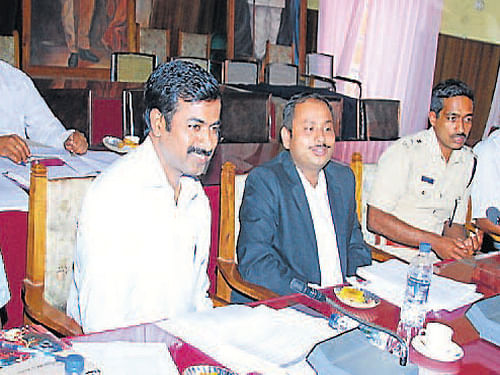 Deputy Commisioner Anurag Tiwari speaks at a district-level meeting in Madikeri on Thursday. SP M N Anucheth, Additional DC H Prasanna and others look on. DH Photo