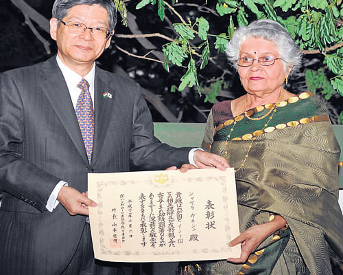 Nobuaki Yamamoto, head of the Consulate of Japan in  Bangalore, presents the commendation award to Shyamala Ganesh in the City on Thursday. DH Photo
