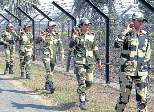 in the frontline: BSF women constables keep vigil along the India-Bangladesh border near Balurghat in the South Dinajpur  district of West Bengal on Friday.  PTI