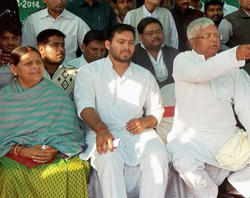 RJD chief Lalu Prasad, his wife Rabri Devi and son Tejaswi during an election meeting in Chapra on Friday. PTI