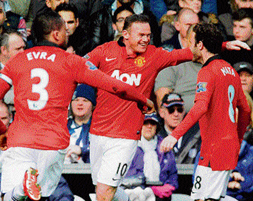on target Manchester United's Wayne Rooney (centre) celebrates his goal against  West Bromwich with Juan Mata (right) and Patrice Evra on Saturday. reuters