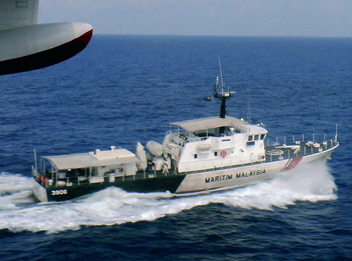 In this photo released by Malaysian Maritime Enforcement Agency, a patrol vessel of Malaysian Maritime Enforcement Agency searches for the missing Malaysia Airlines plane off Tok Bali Beach in Kelantan, Malaysia, Sunday, March 9, 2014. Military radar indicates that the missing Boeing 777 jet may have turned back, Malaysia's air force chief said Sunday as scores of ships and aircraft from across Asia resumed a hunt for the plane and its 239 passengers. (AP Photo)
