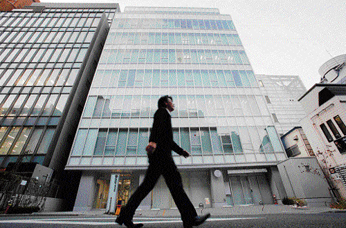 A man walks past a building where Mt. Gox, a digital marketplace operator, is housed in Tokyo. Reuters