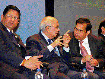Governor H R Bhardwaj shares his views with Century Group MD P Dayanand Pai at an event in Bangalore on Sunday. (Left) Canara Bank MD R K Dubey is also seen. DH photo