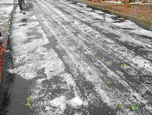A blanket of hailstones covers the road in Kulagod village near Mudalgi in Gokak taluk, Belgaum district, on Sunday.  DH Photo