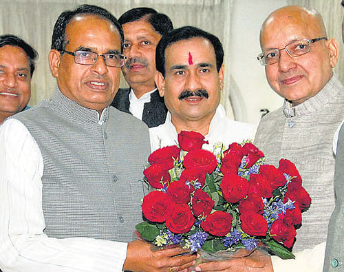 Congress candidate from Bhind parliamentary constituency Bhagirath Prasad (right) being welcomed by Madhya Pradesh Chief Minister Shivraj Singh Chouhan after he  joined Bharatiya Janata Party in Bhopal on Sunday. PTI