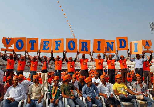 Supporters of Gujarat's chief minister and Hindu nationalist Narendra Modi, the prime ministerial candidate for Bharatiya Janata Party (BJP), hold placards during a rally being addressed by Modi ahead of the 2014 general elections, in Ahmedabad February 20, 2014. REUTERS